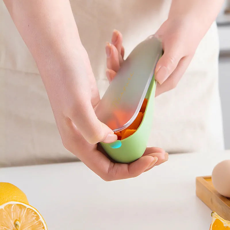 Dark green kitchen peeler with stainless steel blade inside a storage tube
