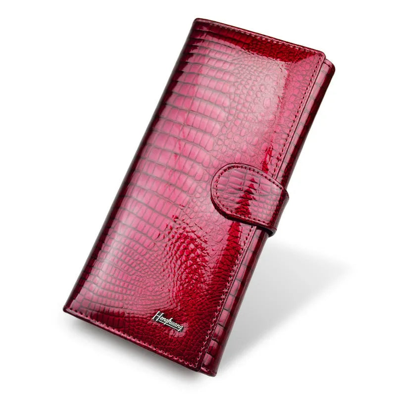 Wine red women's leather coin purse with a shiny crocodile pattern texture and open interior.