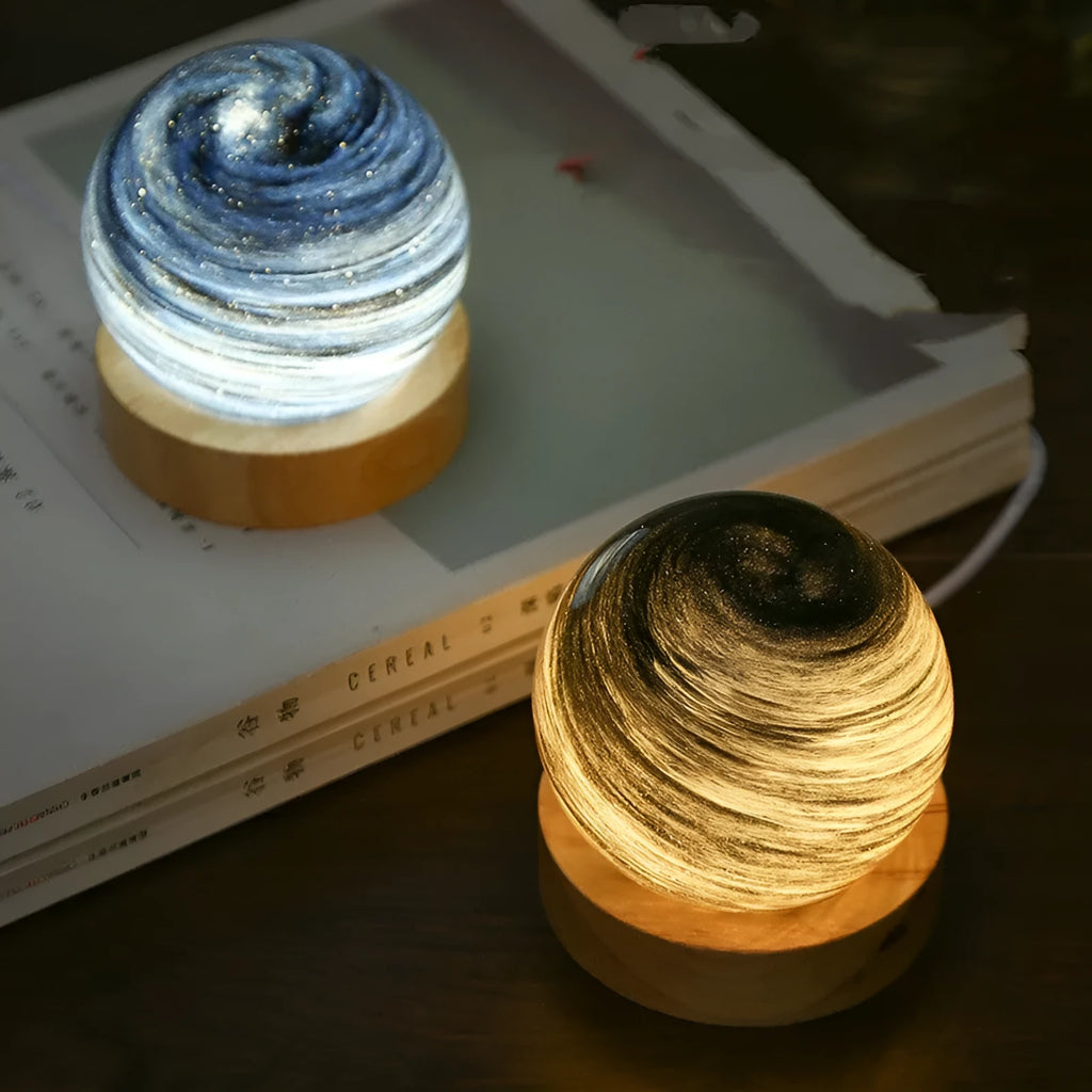 Modern planet-shaped USB night light with dimmable three-colour LED on its base.