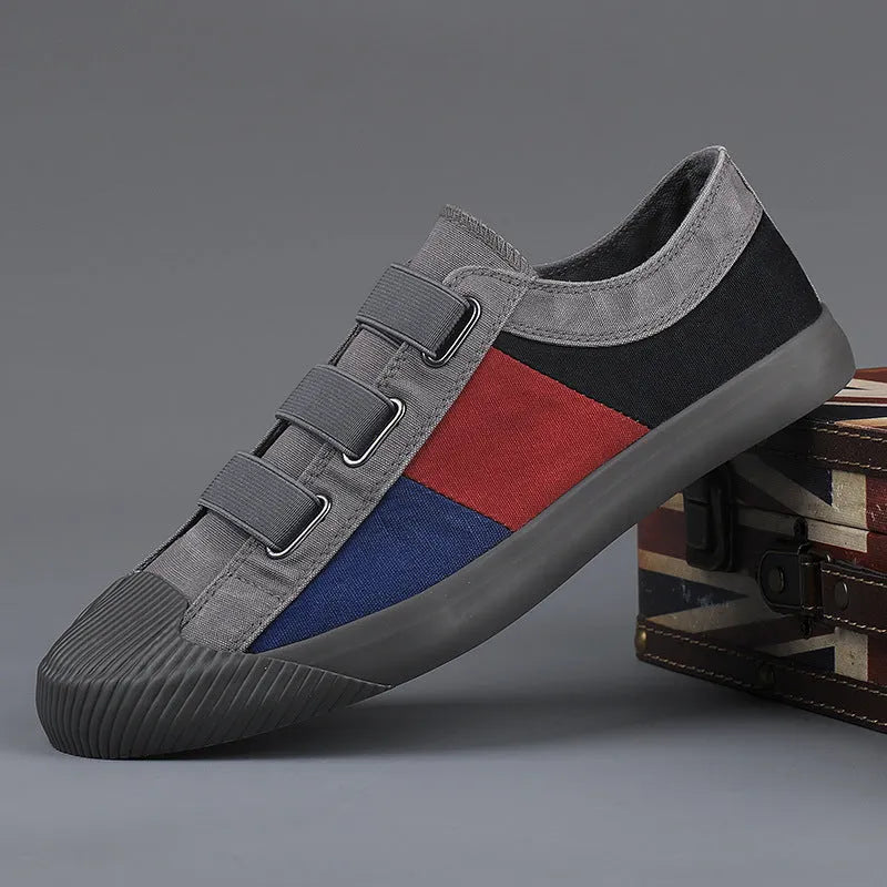 Men's beige canvas low-top sneakers with elastic band fastening and a vulcanised rubber sole.