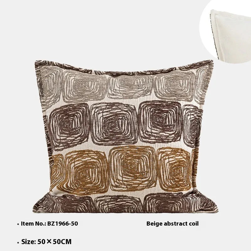 Cream and coffee-coloured abstract coil pattern on a square polyester pillow cover.