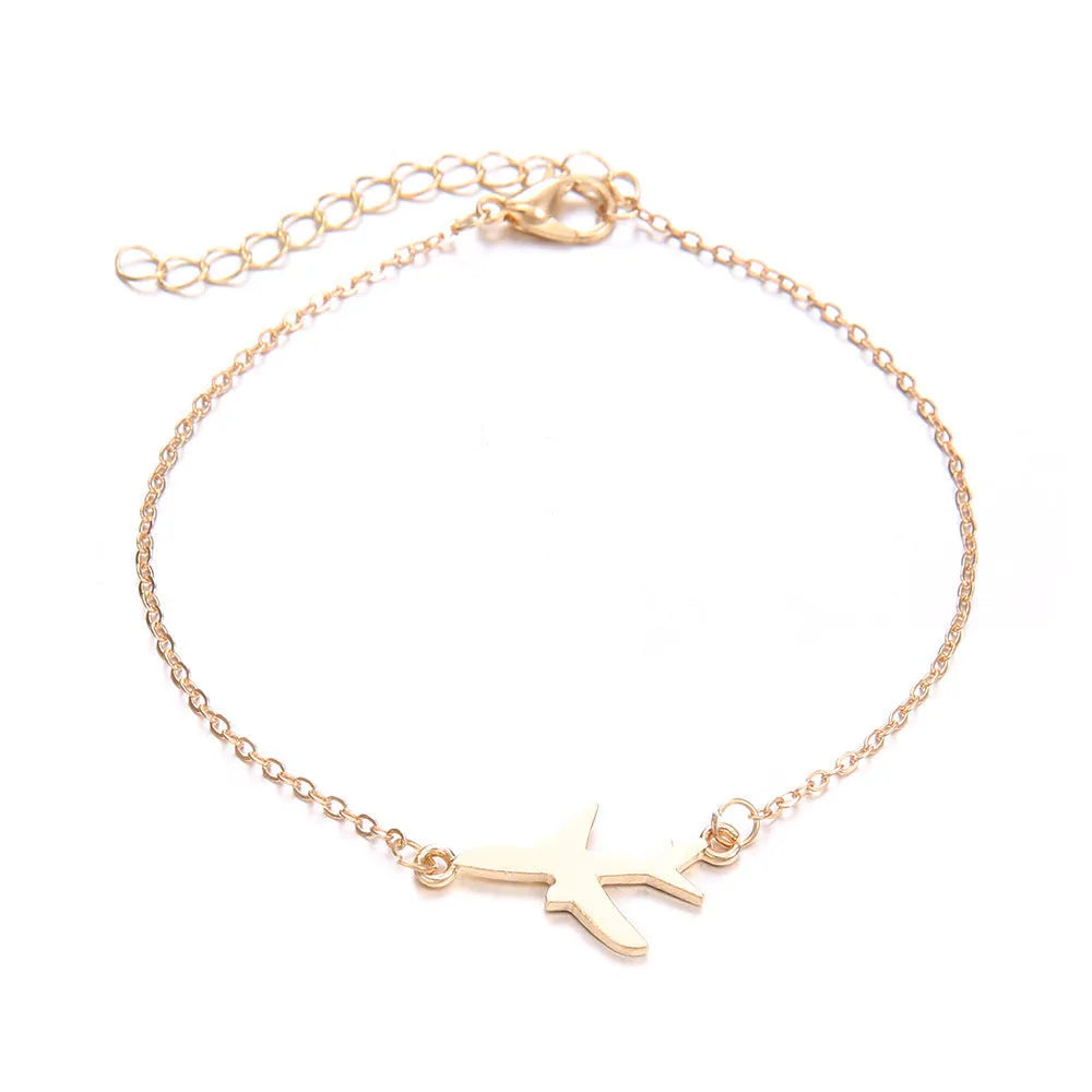 Three bohemian-style alloy bracelets with heart-shaped aircraft map charms on a white background.