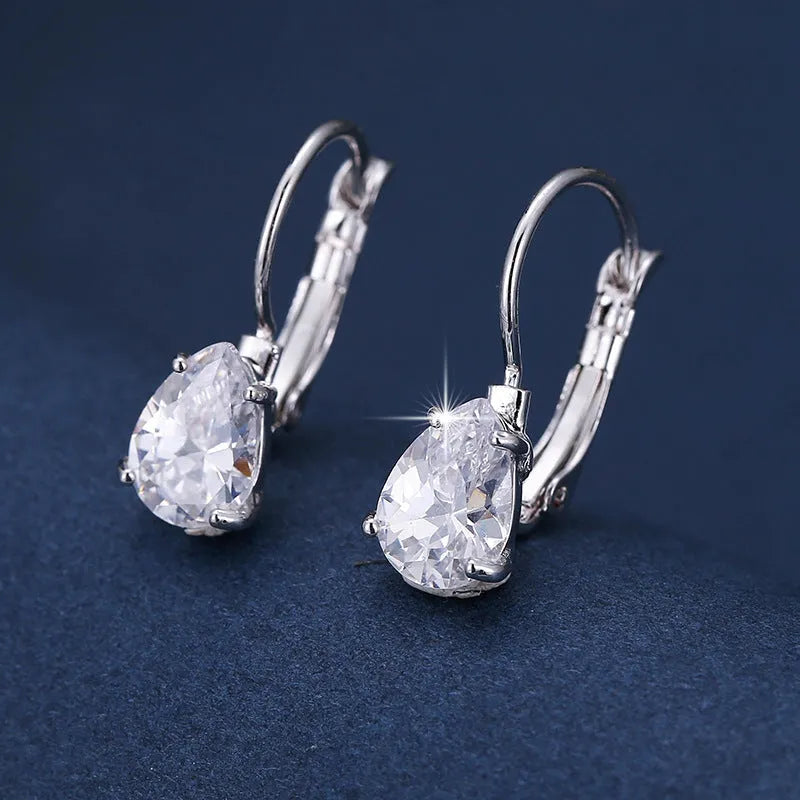 Drop-shaped metal earrings with platinum gem details in gold or platinum colour options