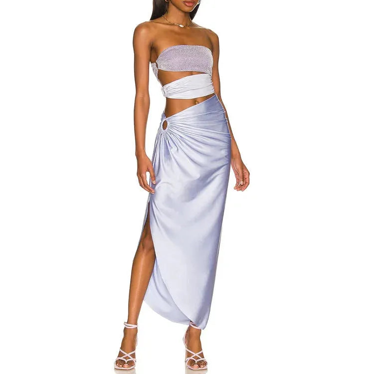 Purple one-piece swimsuit with hollow design and matching wrap skirt on white background