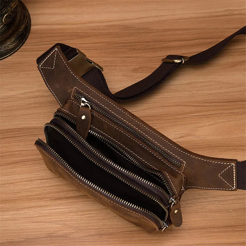 Brown top layer cowhide leather men's sports waist bag with pull-tab closure.