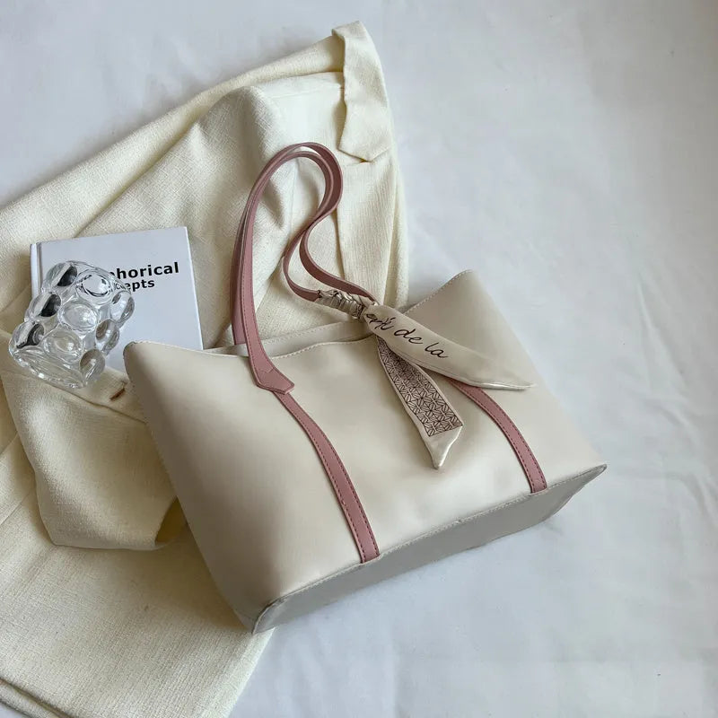 Soft large capacity tote bag with crossbody strap in khaki colour showing outer pocket and sewing line detail