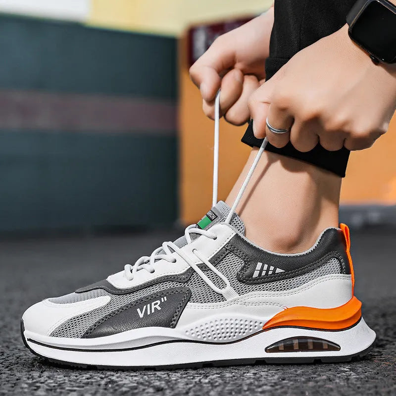 Men's gray and black mesh running shoes with a round toe and middle-top design on a white background.