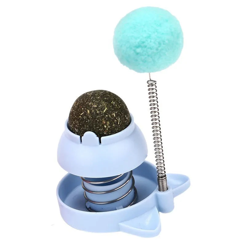 Lucky cat licking mint ball cat toy in blue, orange, and pink colours measuring 55mm diameter