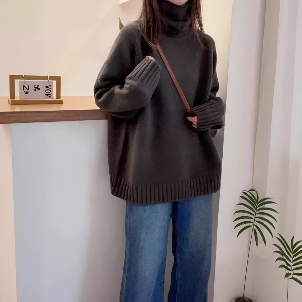 Women's loose-fit turtleneck sweater with a thick, textured curling pile collar in a grey solid colour.
