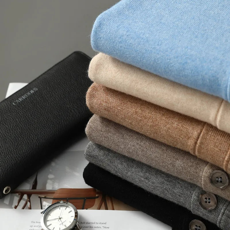 Man wearing a beige V-neck Andy velvet cardigan coat with a loose fit and long sleeves.