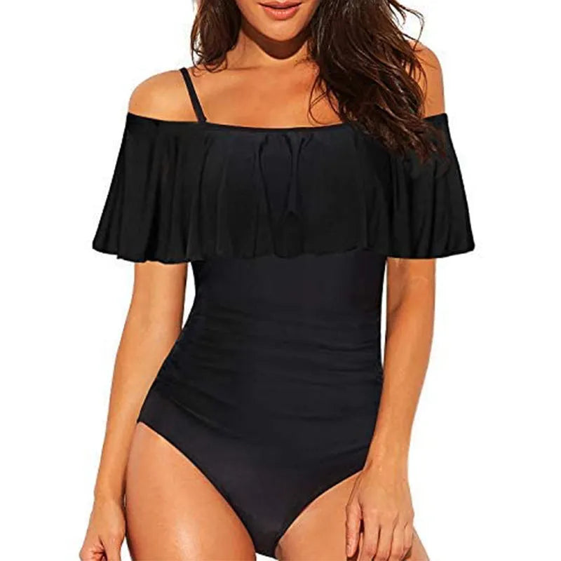 Black women's strapless one-piece swimsuit with a cut-out detail and ruffled strap.
