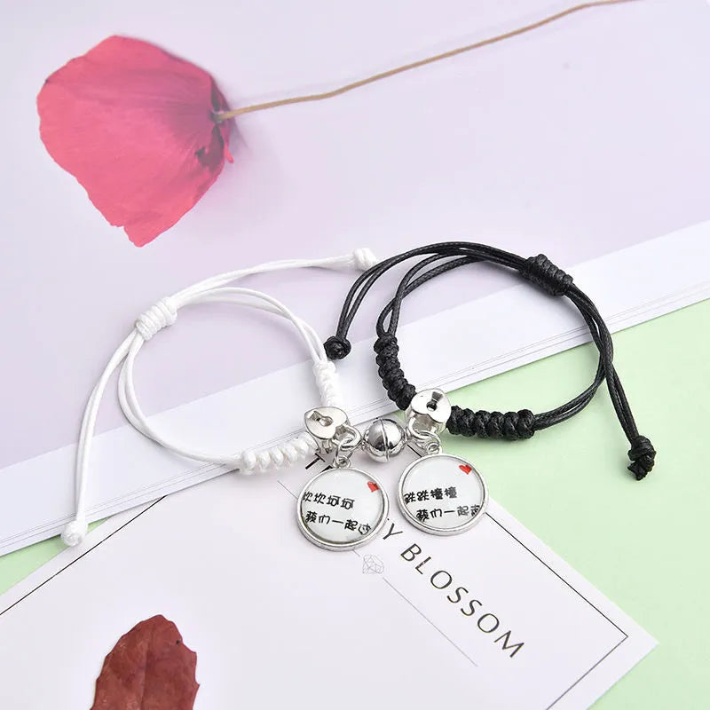 Alloy couple bracelets with magnet closure showing various design options including crown, clover, and text patterns