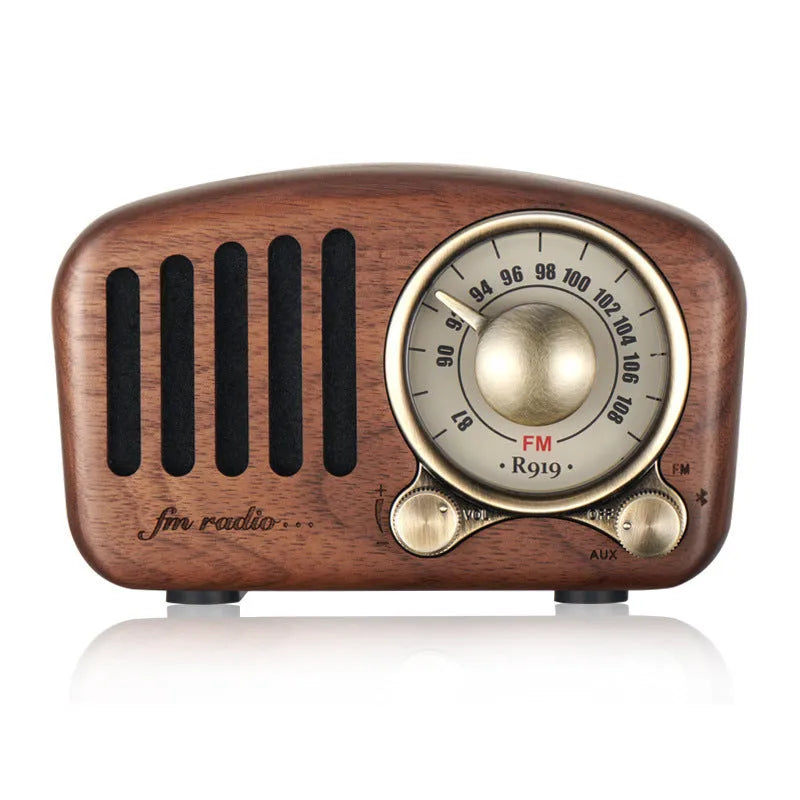 Retro wooden wireless mini speaker in cherry wood finish showing front grille and compact size