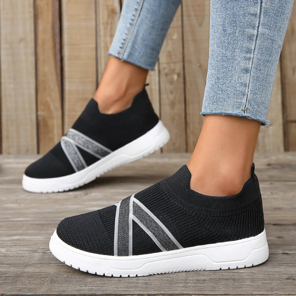 Black women's flat knit mesh shoes with tassel detail and rubber sole