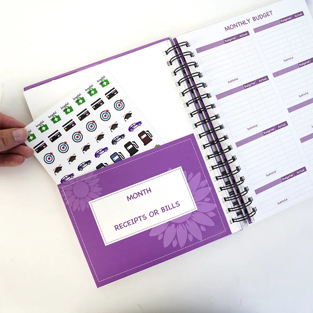 J12 purple coil-bound financial planning notebook with pen and sticker accessories for monthly budgeting