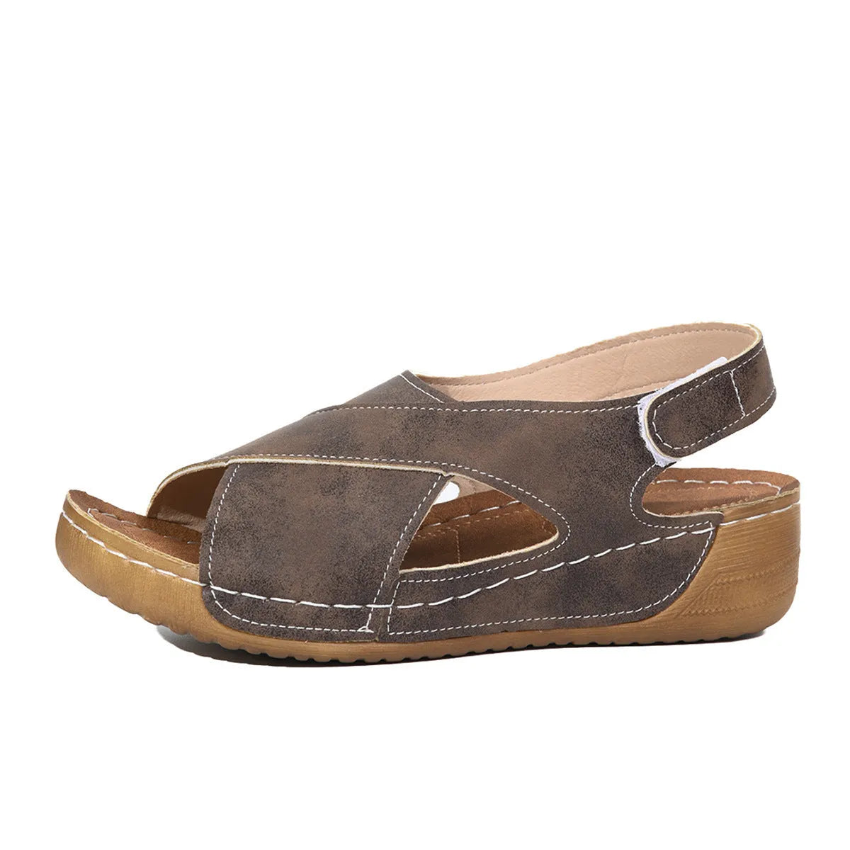 Women's brown platform Roman sandals with Velcro strap and open toe on a rubber sole.