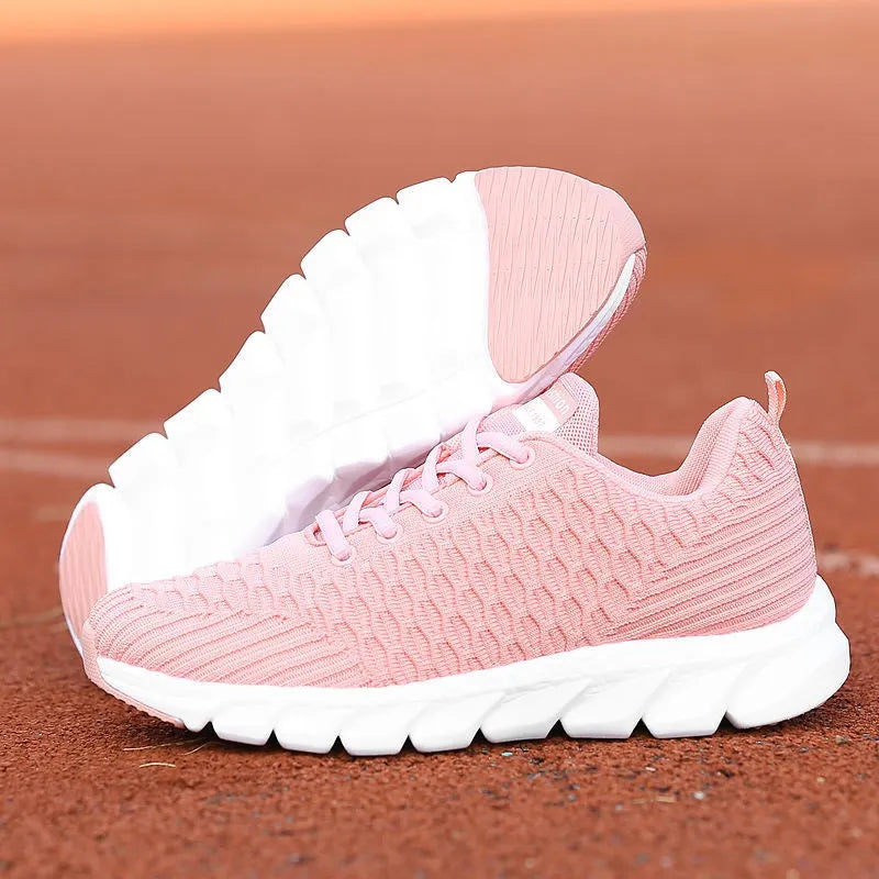 Women's running shoes in black, pink, or white with a breathable fly weave upper and wear-resistant outsole.