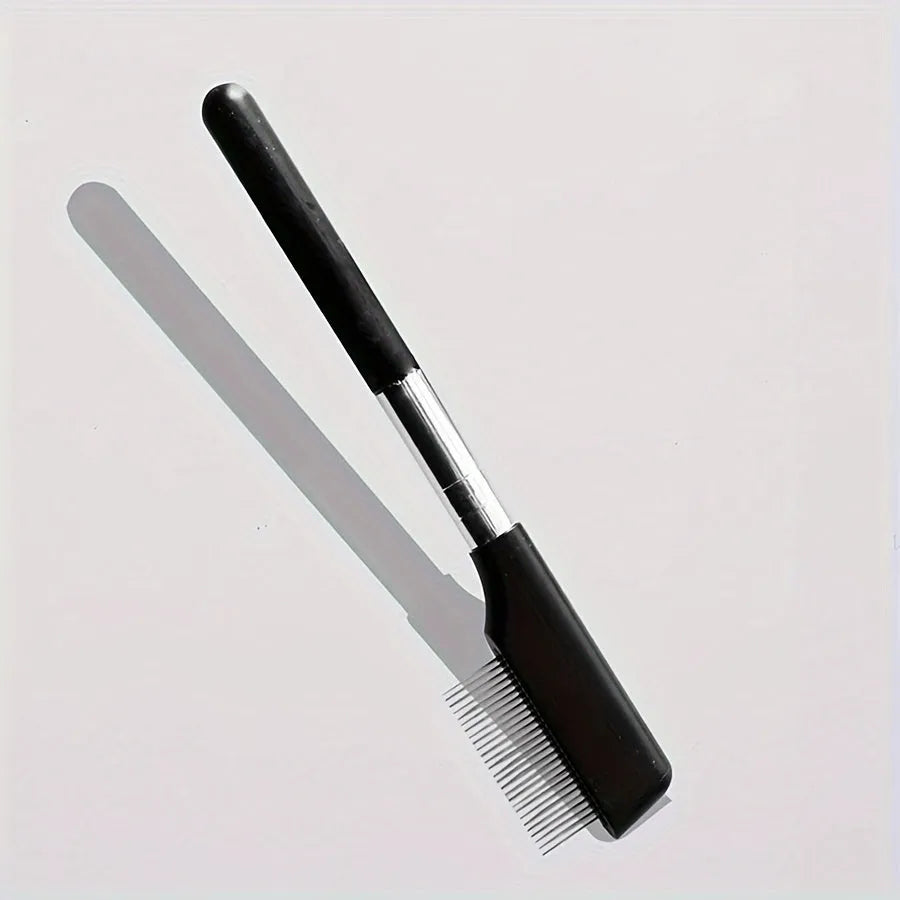 Black pet grooming brush with a soft rubber tear stain remover tool and a plastic comb on an ambidextrous handle.