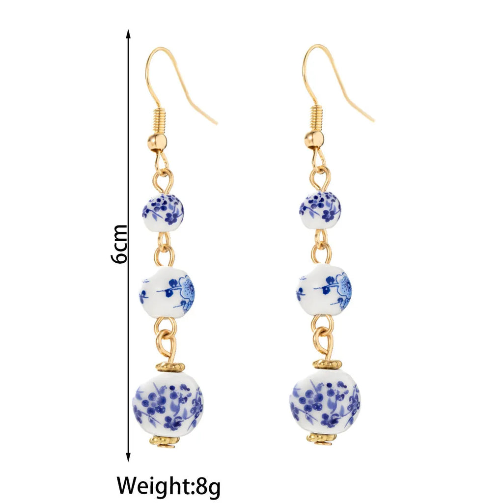 Long blue and white porcelain ceramic bead earrings with alloy frame in a retro Chinese style.