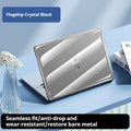 Transparent plastic hard shell protective case for a MacBook laptop on a table.