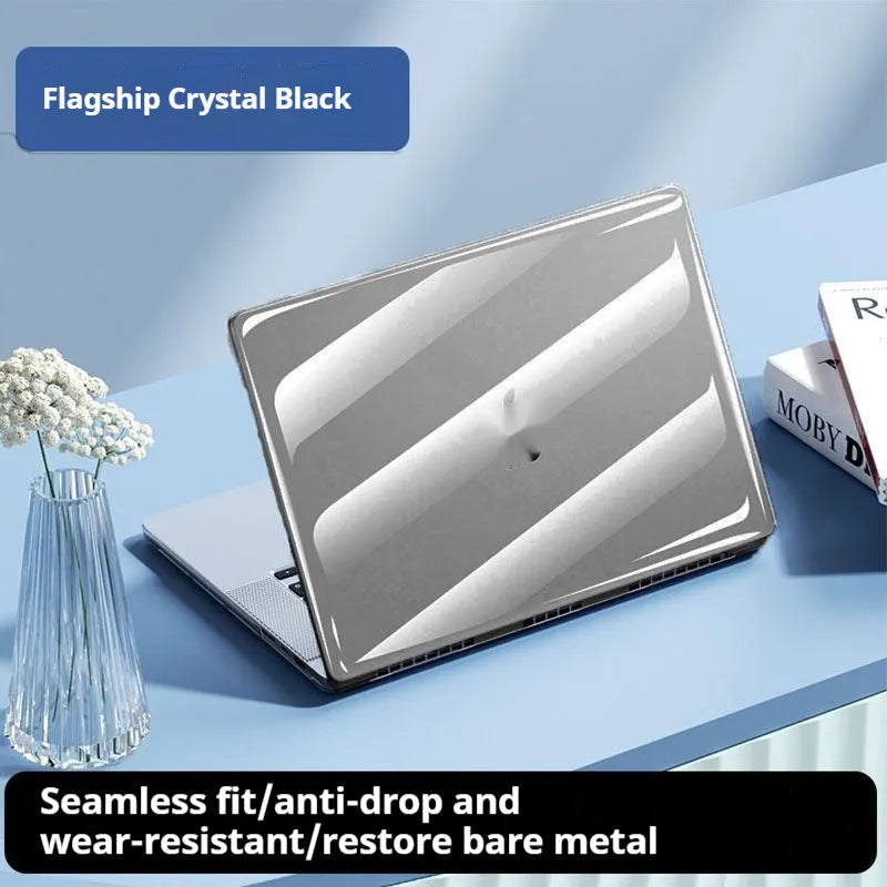 Transparent plastic hard shell protective case for a MacBook laptop on a table.