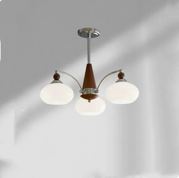 Traditional persimmon glass and chrome chandelier with multiple light heads for a dining room.