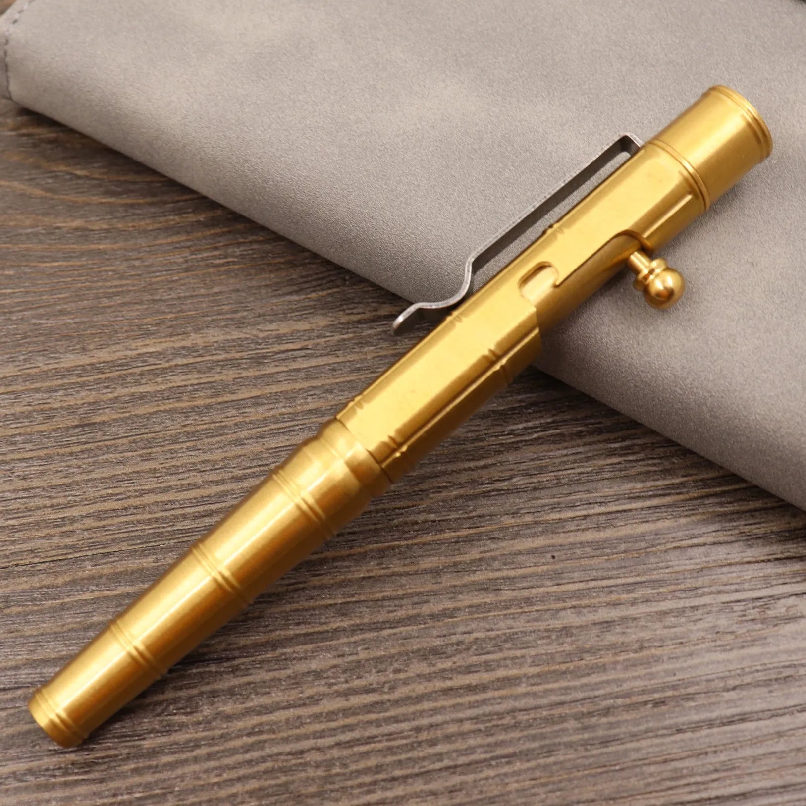 Brass tactical pen with bolt-action mechanism and retro brushed finish