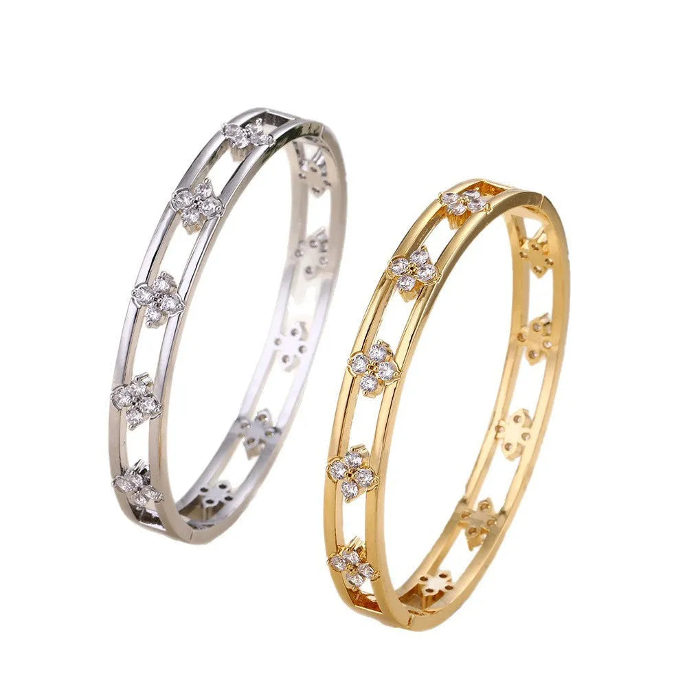 Women's hollow bracelet with four-leaf clover charm and zircon stones in gold or silver
