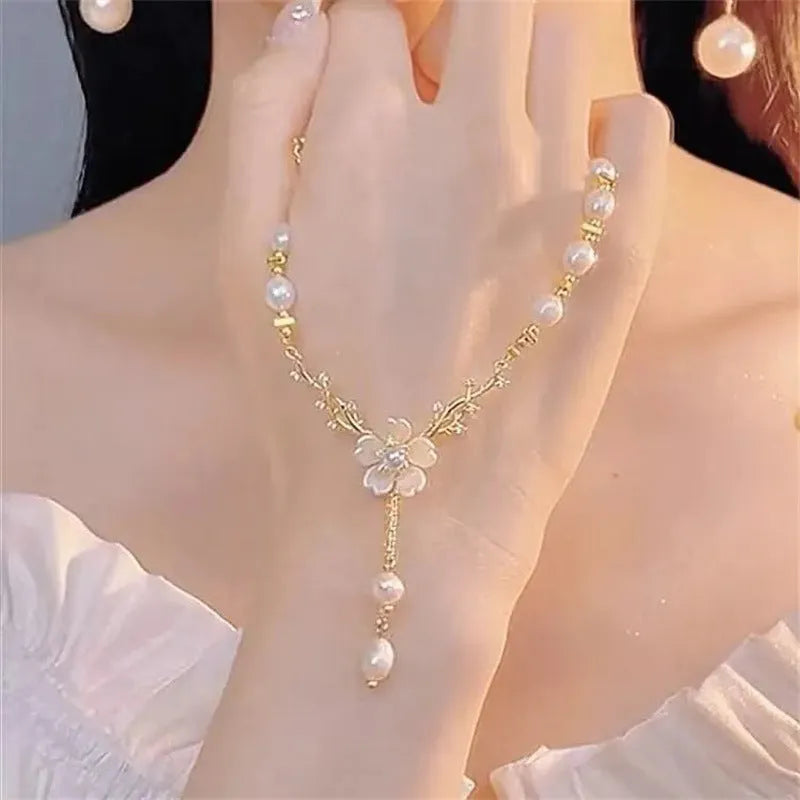 Alloy pearl necklace with floral and rose design elements on a pearl chain.