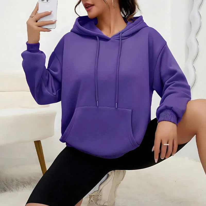 A loose-fitting women's long-sleeve sweatshirt with a drawstring pocket, shown in a solid colour.