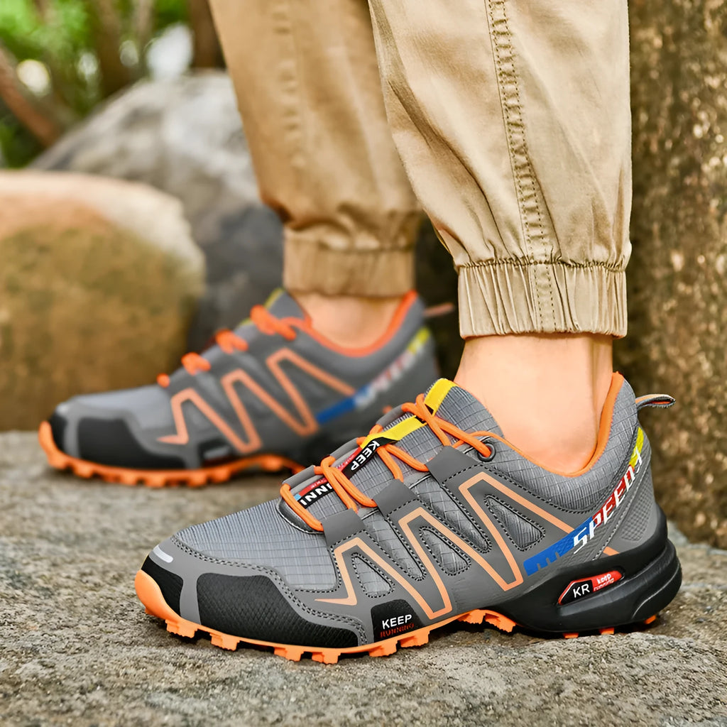 Men's gray orange casual running shoe with synthetic leather upper and low-top design.