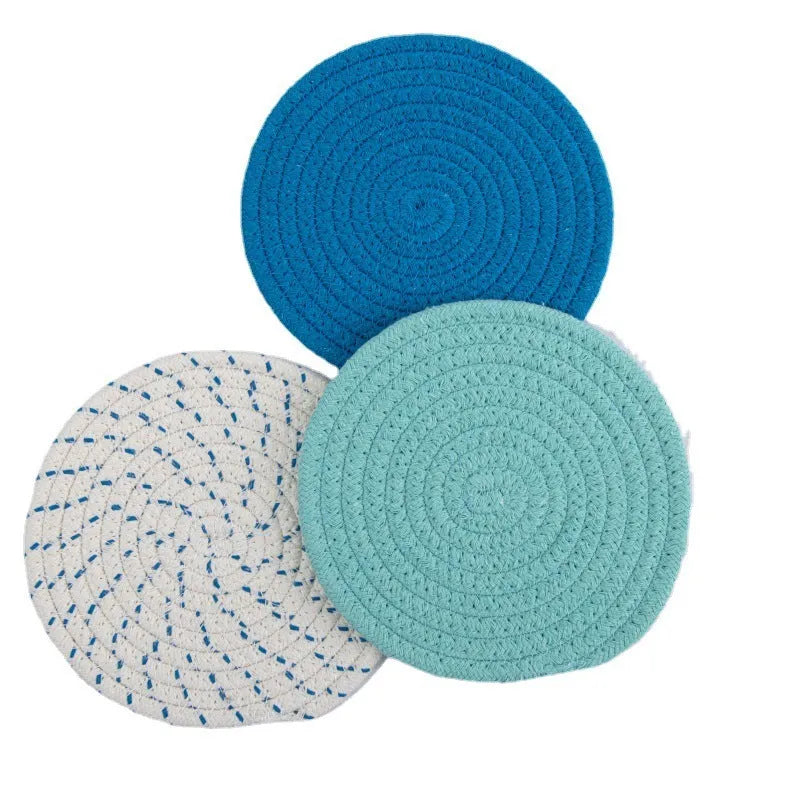 Set of three round grey cotton cord coasters on a wooden table, each 18cm in diameter.