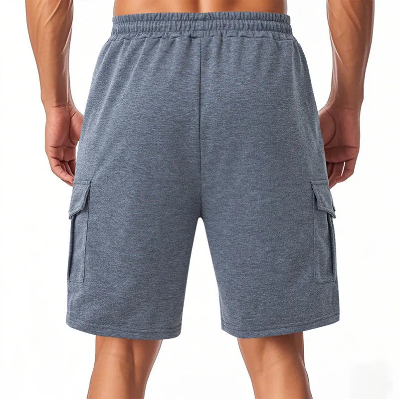 Man's light grey loose-fit cargo shorts made from heavy towel fabric with multiple pockets.