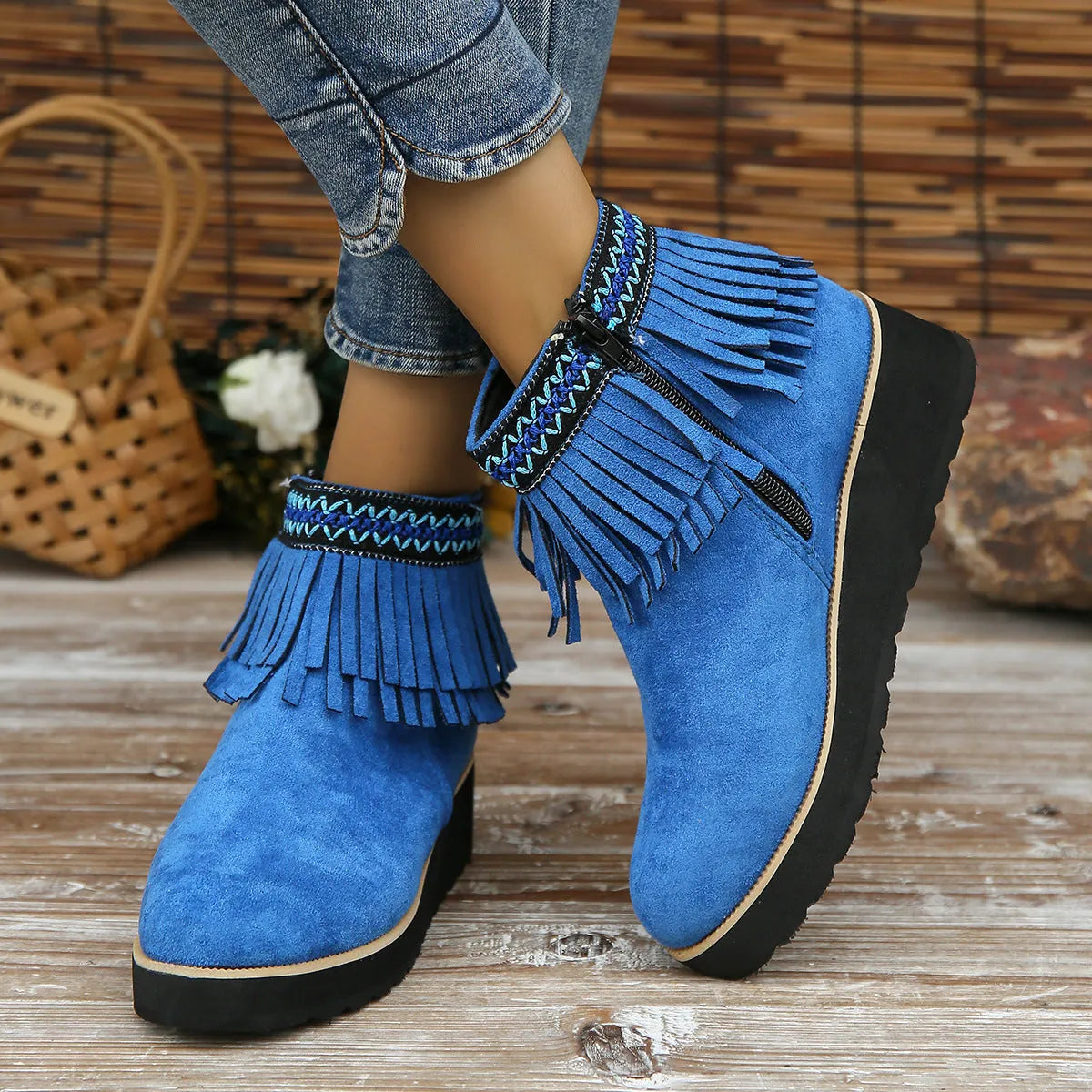 Women's suede ankle boot with wedge heel, side zipper, and tassel detail in dark brown.