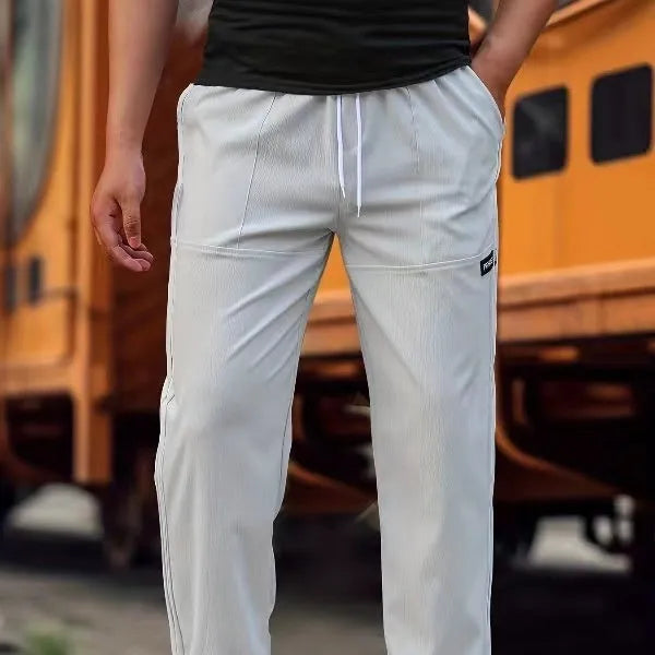 Men's straight-leg lightweight polyester trousers in light grey colour, laid flat showing front design