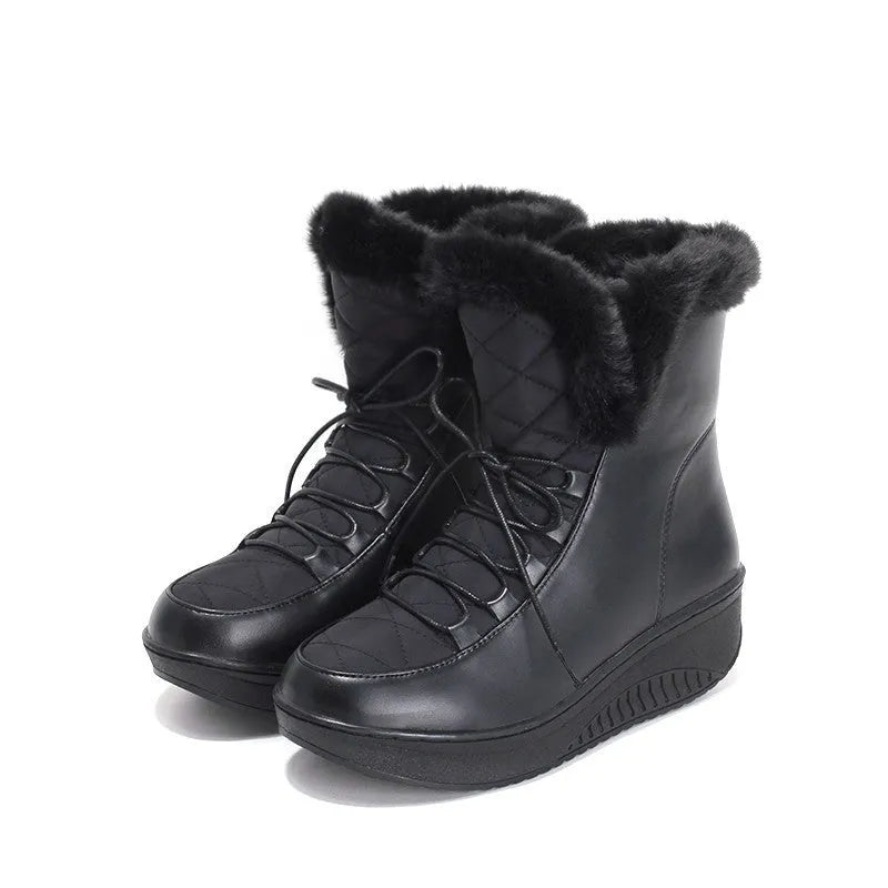 Black women's lace-up winter ankle boots with a platform sole on a white background