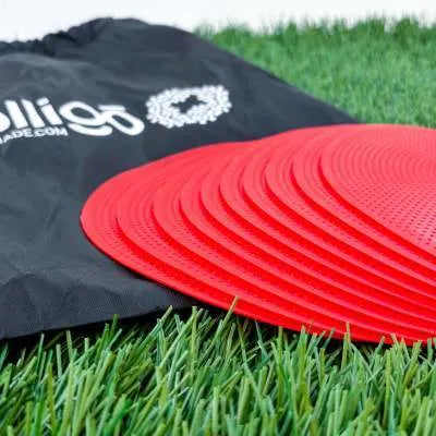 Flat, round yellow football training target disc with 23cm diameter on grass.