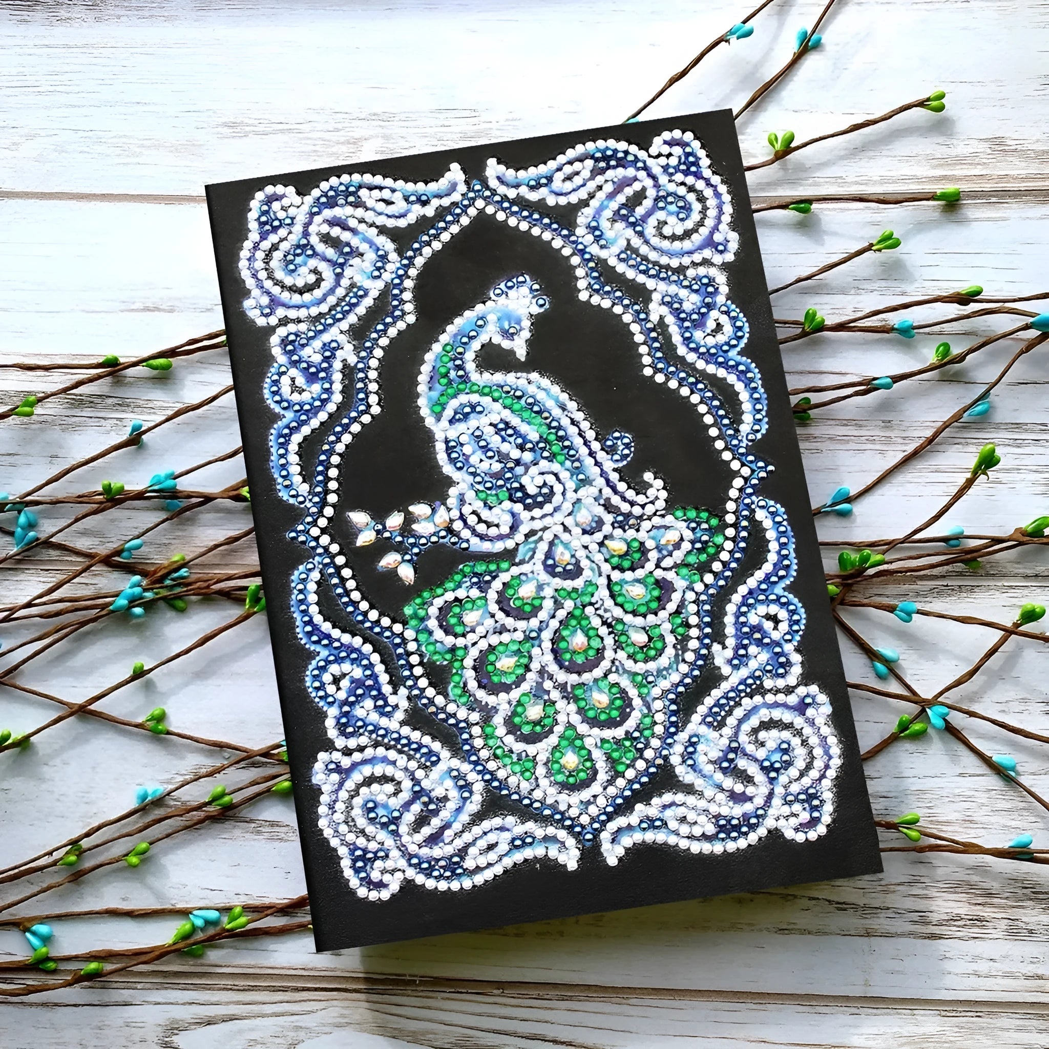 Black A5 diamond painting notebook with peacock design, shaped drills, and OPP packaging