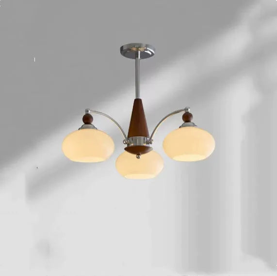 Traditional persimmon glass and chrome chandelier with multiple light heads for a dining room.