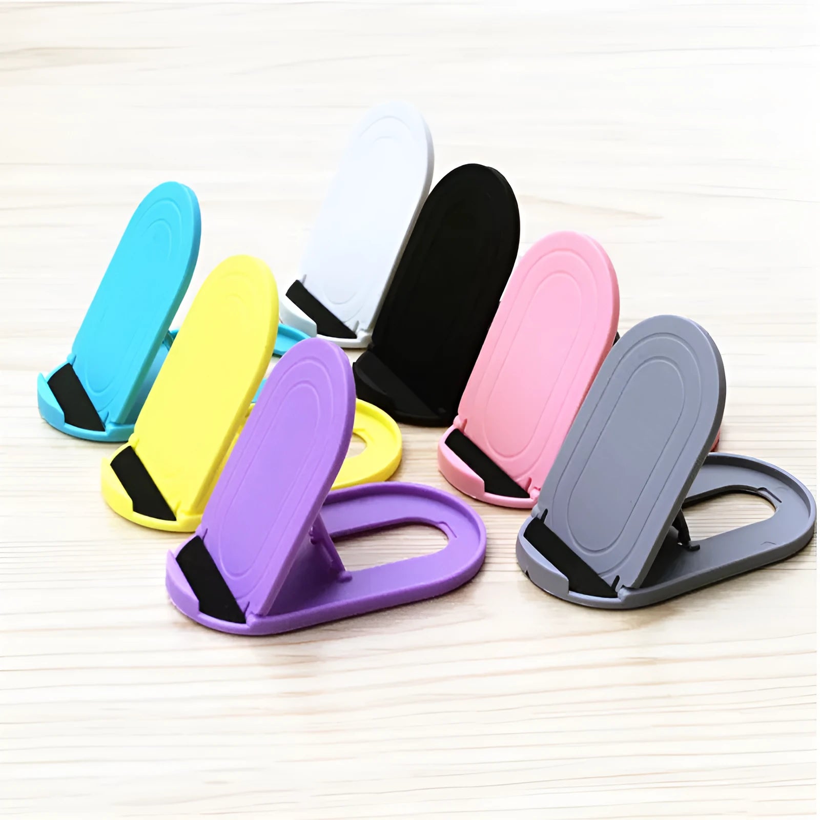 Adjustable plastic mobile phone stand in six colour options showing lazy bracket design