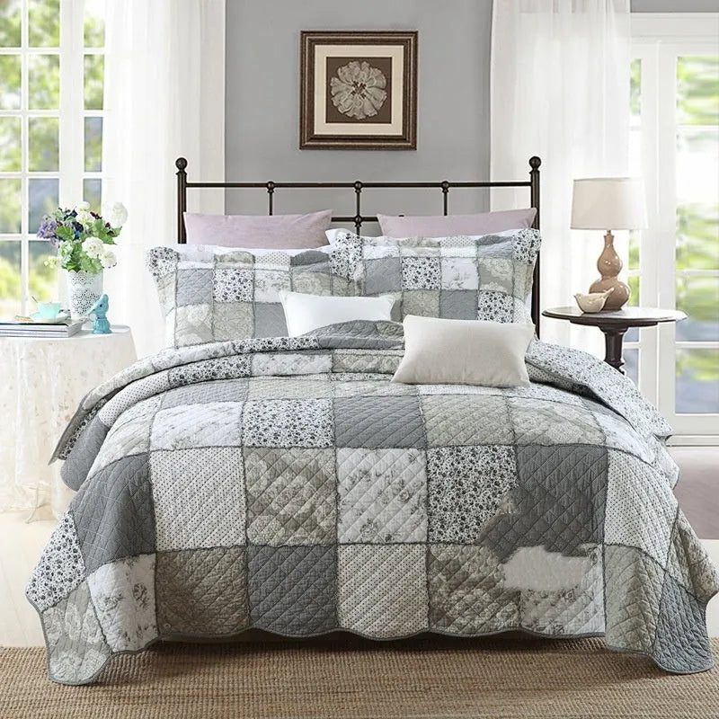 Washed pure cotton quilted bedspread set with one large cover and two pillowcases on a bed.