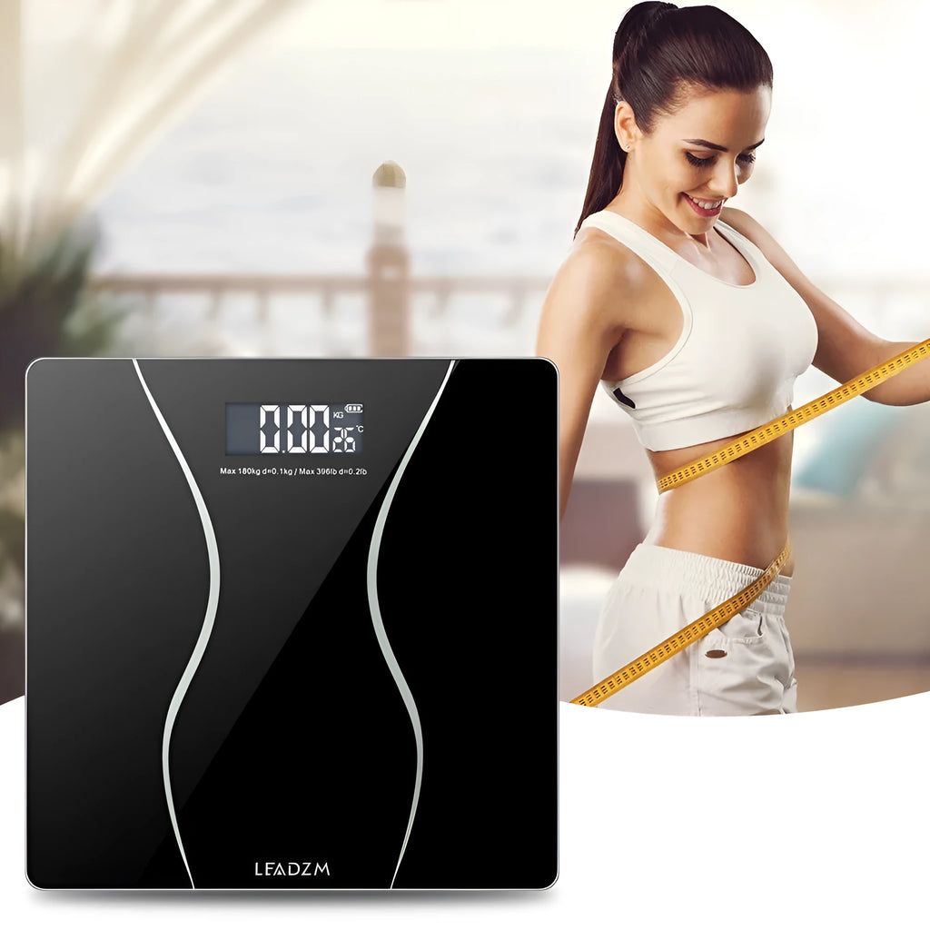 Black electronic bathroom scale with digital display showing weight measurement