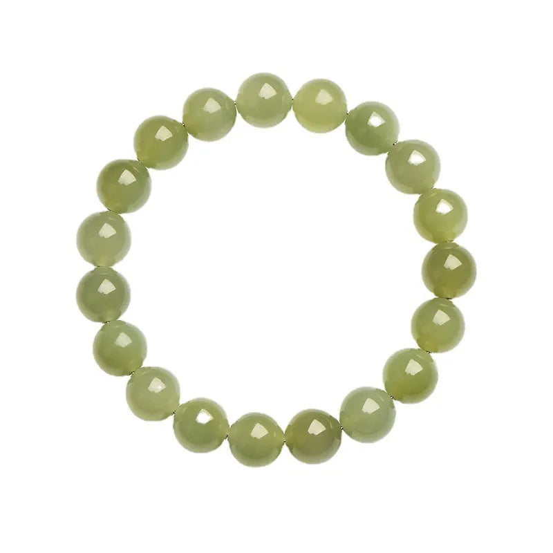 Hetian jade ball bracelet with polished beads in clear water colour on a string.