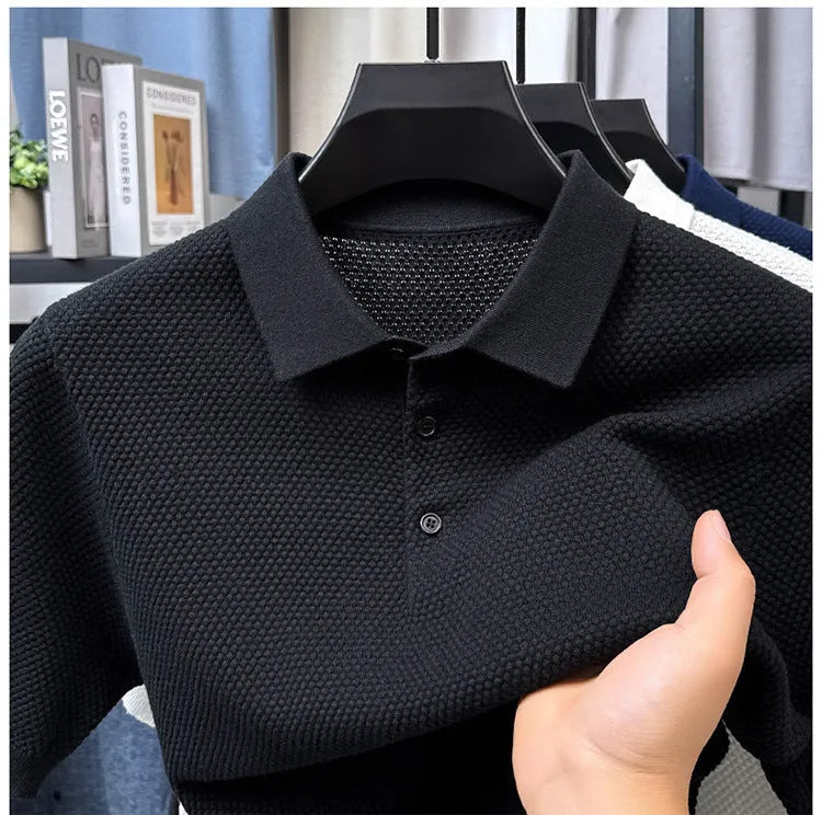 Man wearing a loose fit short sleeve cotton sweater in grey, showing the pullover style and relaxed silhouette.