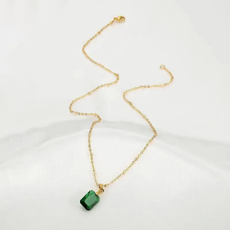 Copper geometric necklace with green rectangular quadrilateral pendant on an O-ring chain.