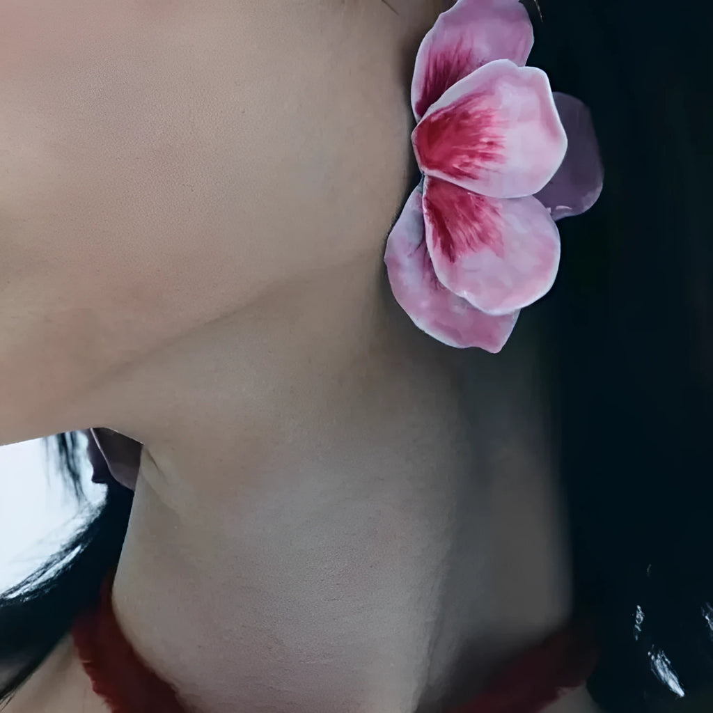 Close-up of women's alloy flower stud earrings with a blue oil-spot glaze and electroplated finish.