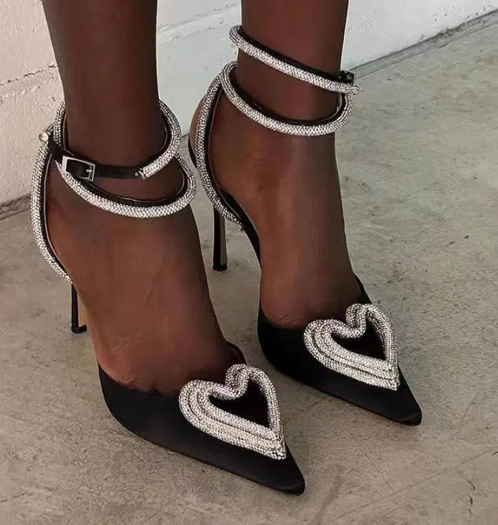 Women's pink satin sandal with heart-shaped rhinestone decoration and pointed toe.