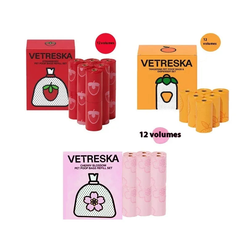 Portable dog poop bag dispenser capsule in strawberry, orange, and cherry blossom patterns with a roll of scented bags.