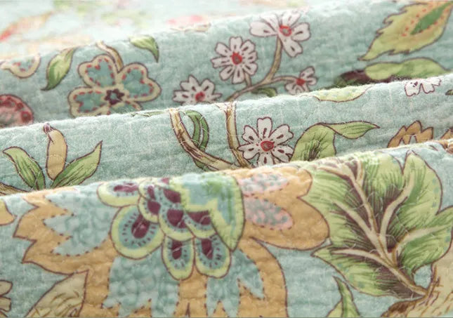 Blue American-style cotton bedspread with floral bird pattern and quilting texture