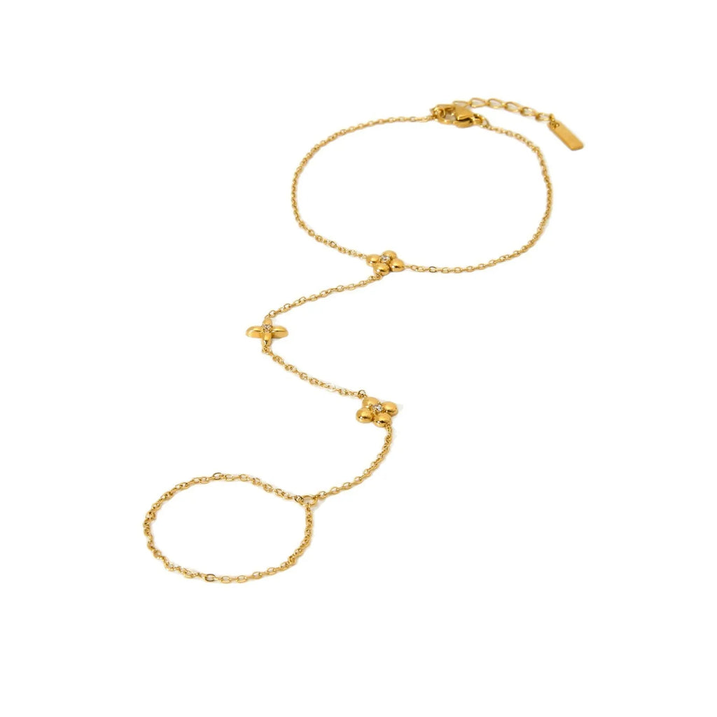 Gold stainless steel women's bracelet with floral and eight-pointed star geometric design.